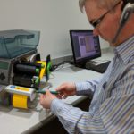 Neumann Marking Technician Performing Printer Maintenance